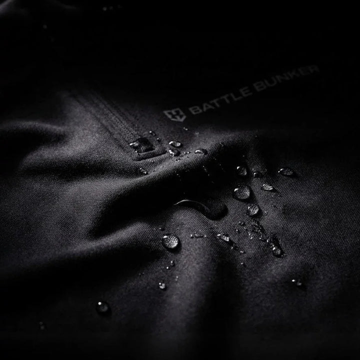 Close-up of black Battle Bunker fabric with water droplets showcasing waterproof textile and branding